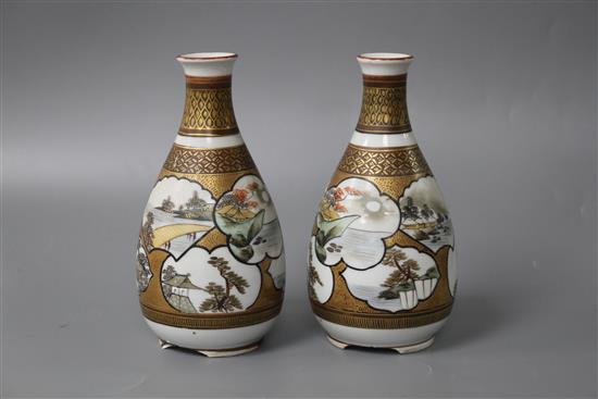 A pair of Kutani porcelain vases, decorated with landscape panels, signed to the underside, height 13.75cm